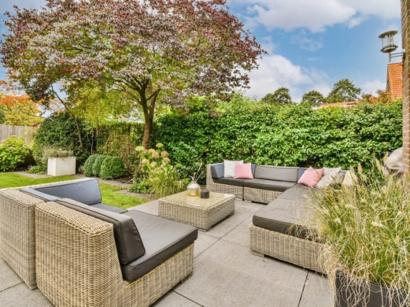 An,Outdoor,Living,Area,With,Wickers,And,Plants,On,The